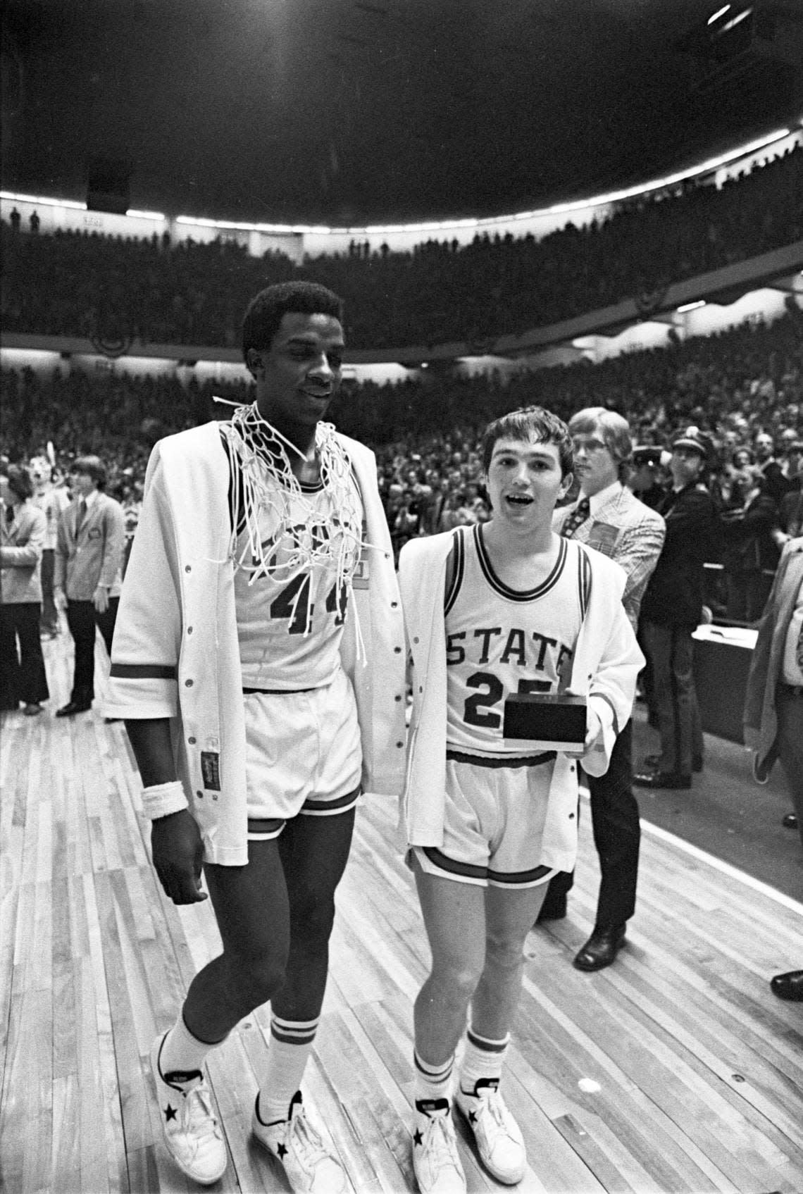 NC State’s David Thompson (left) and Monte Towe (right) leave the court after the trophy presentation following the Wolfpack’s 1974 National Championship win over Marquette.