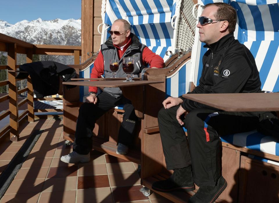 Russian President Putin and PM Medvedev chat during their visit to the "Laura" cross country ski and biathlon centre in the resort of Krasnaya Polyana near Sochi