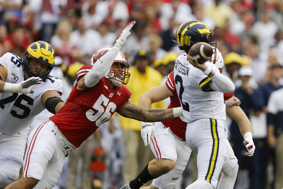 Wisconsin defensive end Rodas Johnson (56) goes after Michigan quarterback Shea Patterson (2) during the first half of an NCAA college football game Saturday, Sept. 21, 2019, in Madison, Wis. (AP Photo/Andy Manis)