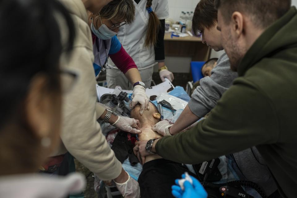 Medical workers try unsuccessfully to save the life of Marina Yatsko's 18-month-old son Kirill, who was killed by shelling, at a hospital in Mariupol, Ukraine, March 4, 2022. The image was part of a series of images by Associated Press photographers that was awarded the 2023 Pulitzer Prize for Breaking News Photography. (AP Photo/Evgeniy Maloletka)