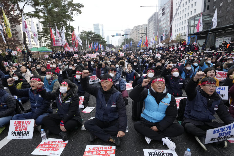 Members of the Korean Confederation of Trade Unions shout slogans during a rally against the government's labor policy near the National Assembly in Seoul, South Korea, Saturday, Dec. 3, 2022. Thousands of demonstrators representing organized labor marched in South Korea's capital on Saturday denouncing government attempts to force thousands of striking truckers back to work after they walked out in a dispute over the price of freight. (AP Photo/Ahn Young-joon)