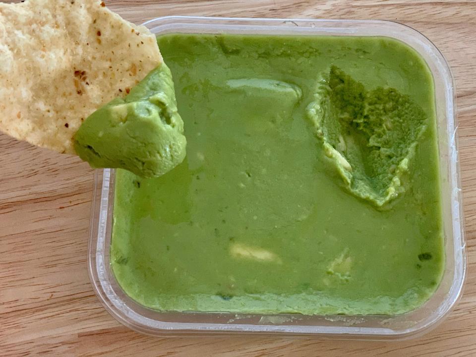 chip dipping into trader joe's avocado number guacamole