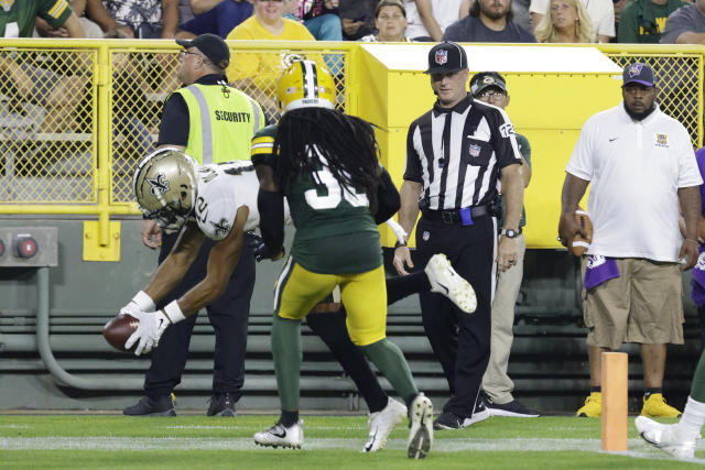 New Orleans Saints wide receiver Chris Olave (12) scores his first NFL touchdown reception during the first half of a preseason football game against the Green Bay Packers Friday, Aug. 19, 2022, in Green Bay, Wis. (AP Photo/Mike Roemer)