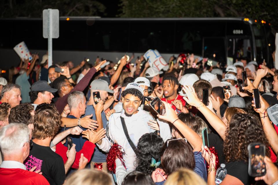 Florida Atlantic guard Nick Boyd leads his teammates through a crowd of supporters welcoming the team home at Baldwin Arena on the FAU campus on Sunday, March 26, 2023, in Boca Raton, FL. After defeating Kansas State Saturday to advance to the NCAA Tournament Final Four for the first time in school history, the men's basketball team returned to campus and was welcomed by a crowd of supporters.