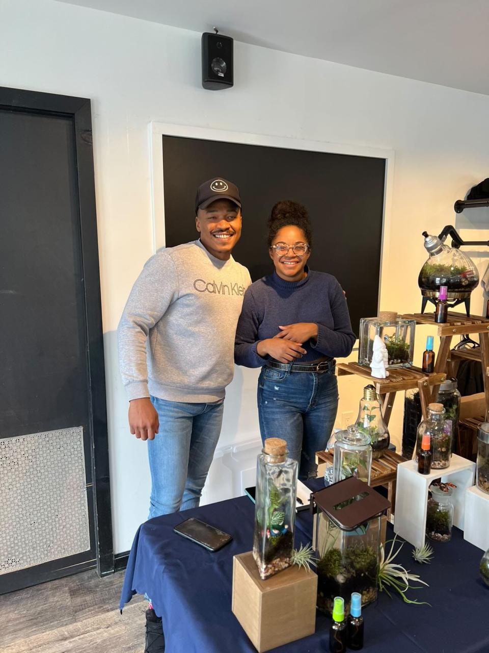 Kiana Jones, owner of Plush Moon Terrarium Co., with her friend Eric Thomas at an event at Hey Bear Café.