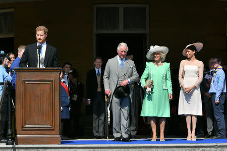 Britain's Prince Harry and his wife Meghan, Duchess of Sussex, at a garden party at Buckingham Palace with Prince Charles and Camilla the Duchess of Cornwall, their first royal engagement as a married couple, in London, May 22, 2018. Dominic Lipinski/Pool via Reuters