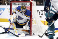 St. Louis Blues goaltender Joel Hofer (30) blocks a shot on goal by San Jose Sharks right wing Filip Zadina (18) in the first period of an NHL hockey game in San Jose, Calif., Saturday, April 6, 2024. (AP Photo/Scot Tucker)