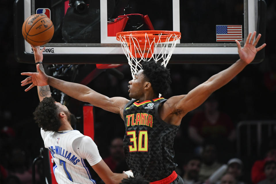 Orlando Magic guard Michael Carter-Williams shoots as Atlanta Hawks center Damian Jones (30) defends during the second half of an NBA basketball game Wednesday, Feb. 26, 2020, in Atlanta. Orlando won 130-120. (AP Photo/John Amis)