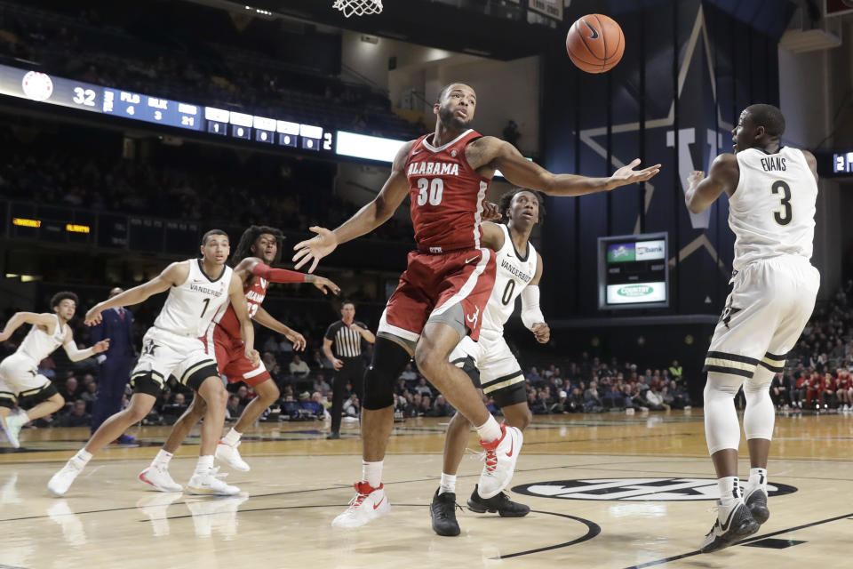 Alabama forward Galin Smith (30) pulls in a rebound in front of Vanderbilt guard Maxwell Evans (3) in the first half of an NCAA college basketball game Wednesday, Jan. 22, 2020, in Nashville, Tenn. (AP Photo/Mark Humphrey)