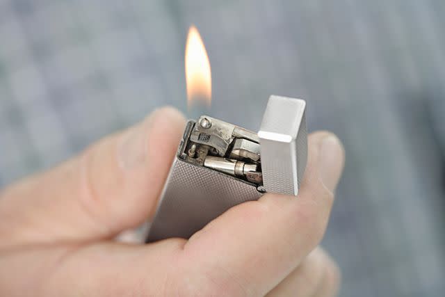 <p>Getty</p> Lighter with flame.