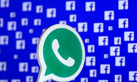 A 3D printed Whatsapp logo is seen in front of a displayed stock graph in this illustration taken April 28, 2016. REUTERS/Dado Ruvic/Illustration