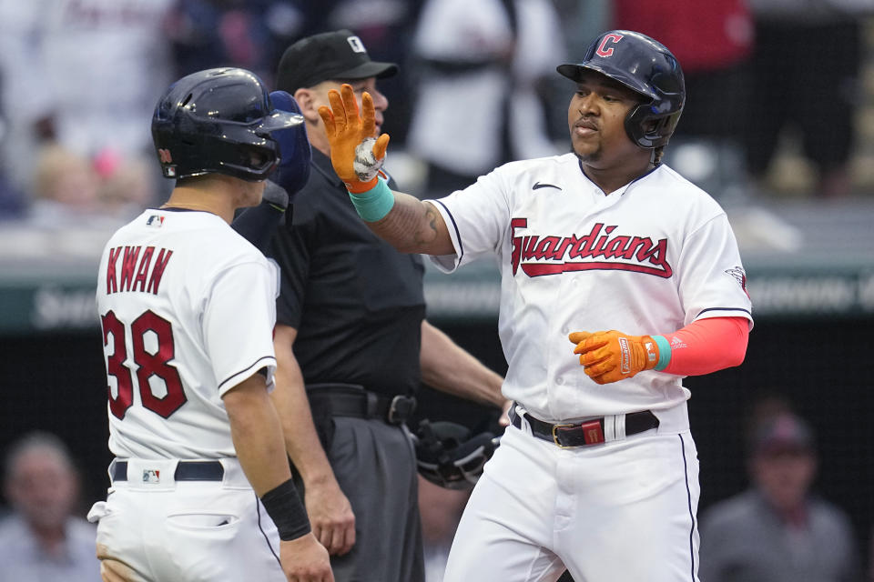 Cleveland Guardians' Jose Ramirez, right, is greeted by Steven Kwan (38) after Ramirez's home run against the Boston Red Sox during the third inning of a baseball game Thursday, June 8, 2023, in Cleveland. It was Ramirez's 200th career home run. (AP Photo/Sue Ogrocki)