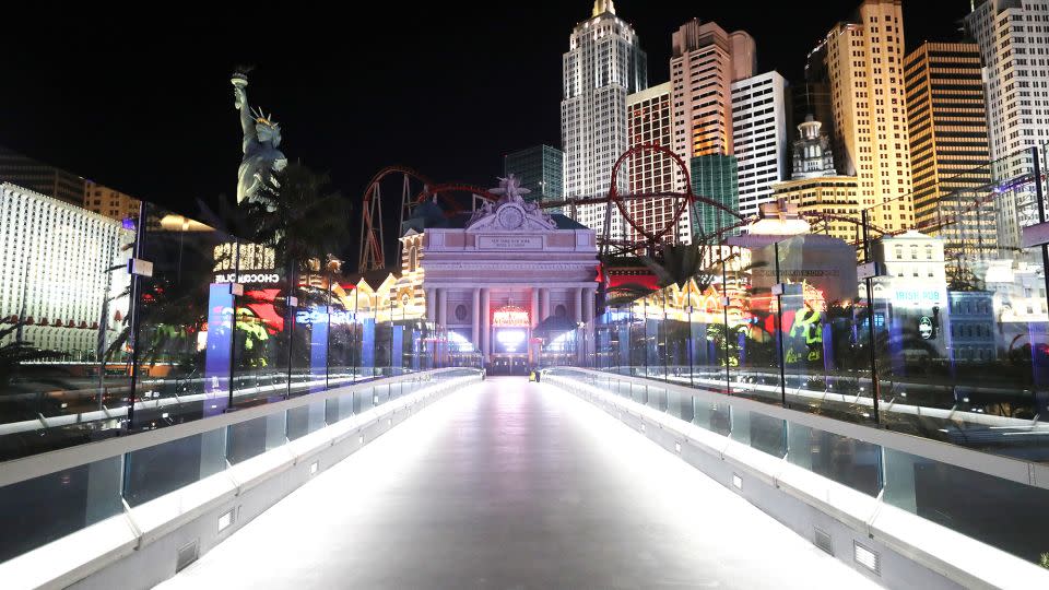 A nearly empty footbridge leads toward New York-New York Hotel & Casino on the Las Vegas Strip, where businesses closed in 2020 in response to the pandemic. - Mario Tama/Getty Images