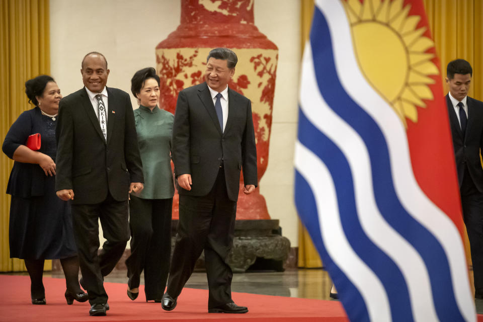 FILE - Kiribati's President Taneti Maamau, left, and Chinese President Xi Jinping walk together during a welcome ceremony at the Great Hall of the People in Beijing, Monday, Jan. 6, 2020. China wants 10 small Pacific nations to endorse a sweeping agreement covering everything from security to fisheries in what one leader warns is a “game-changing” bid by Beijing to wrest control of the region. (AP Photo/Mark Schiefelbein, File)