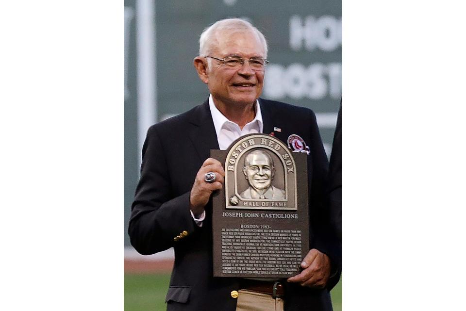 Boston Red Sox broadcaster Joe Castiglione, holds his Boston Red Sox Hall of Fame plaque before a baseball game at Fenway Park in 2014. Castiglione, a Boston Red Sox radio announcer for 41 years, won the Hall of Fame’s Ford C. Frick Award for excellence in broadcasting on Wednesday.
