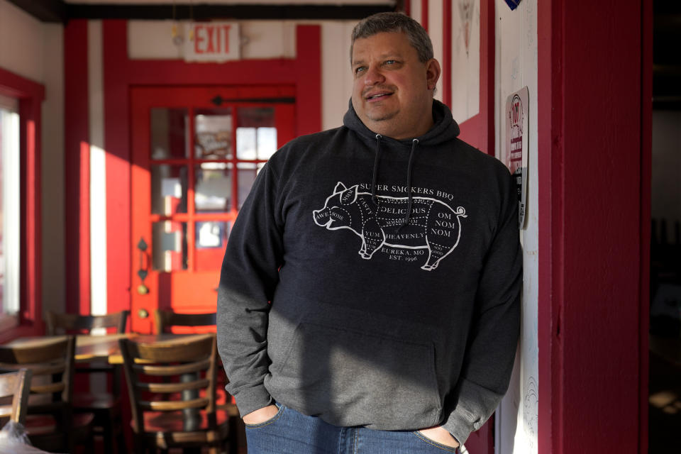 Jeff Fitter, owner of Super Smokers BBQ, poses for a photo inside his restaurant Thursday, Jan. 28, 2021, in Eureka, Mo. Fitter says his profits were down by about half last year, largely because of the closures and capacity limits imposed by St. Louis County. He is supporting a bill that would limit local emergency health orders to 14 days unless authorized for longer by the Legislature. (AP Photo/Jeff Roberson)