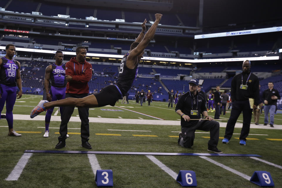 FILE - Connecticut defensive back Byron Jones runs a drill at the NFL football scouting combine in Indianapolis, Monday, Feb. 23, 2015. Byron Jones was the top performer in the broad jump at the NFL scouting combine in 2015. (AP Photo/Julio Cortez, File)