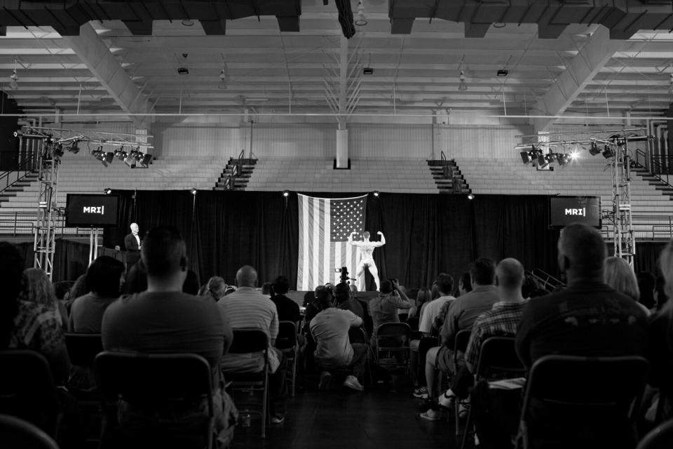 A bodybuilder performs on stage at The Texas Shredder. Competitors are allowed to choreograph their routines and choose their own music.