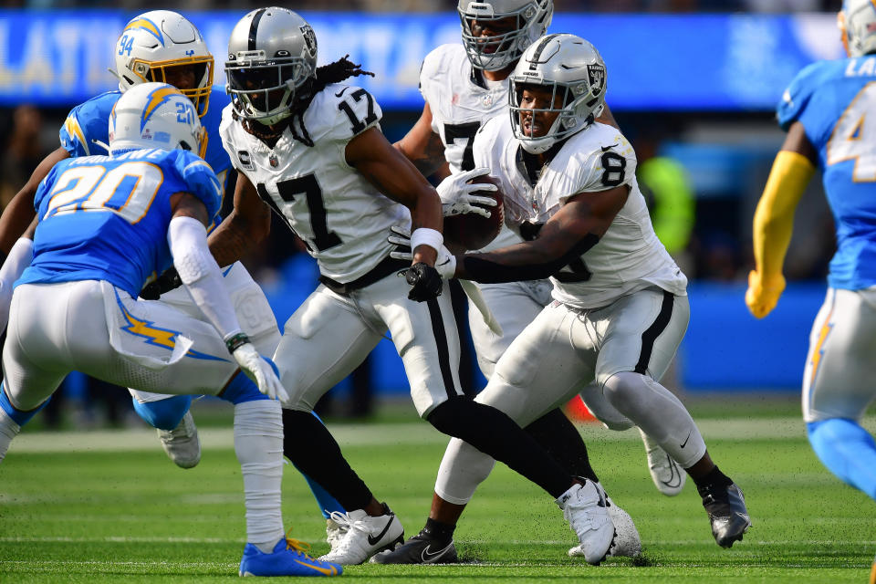 Oct 1, 2023; Inglewood, California, USA; Las Vegas Raiders running back <a class="link " href="https://sports.yahoo.com/nfl/players/31856" data-i13n="sec:content-canvas;subsec:anchor_text;elm:context_link" data-ylk="slk:Josh Jacobs;sec:content-canvas;subsec:anchor_text;elm:context_link;itc:0">Josh Jacobs</a> (8) runs the ball as wide receiver Davante Adams (17) provides coverage against <a class="link " href="https://sports.yahoo.com/nfl/teams/la-chargers/" data-i13n="sec:content-canvas;subsec:anchor_text;elm:context_link" data-ylk="slk:Los Angeles Chargers;sec:content-canvas;subsec:anchor_text;elm:context_link;itc:0">Los Angeles Chargers</a> safety Dean Marlowe (20) during the second half at SoFi Stadium. Mandatory Credit: Gary A. Vasquez-USA TODAY Sports