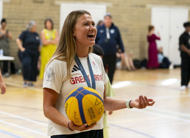 Rower Lola Anderson plays basketball with children during the photocall at North Paddington Youth Club 