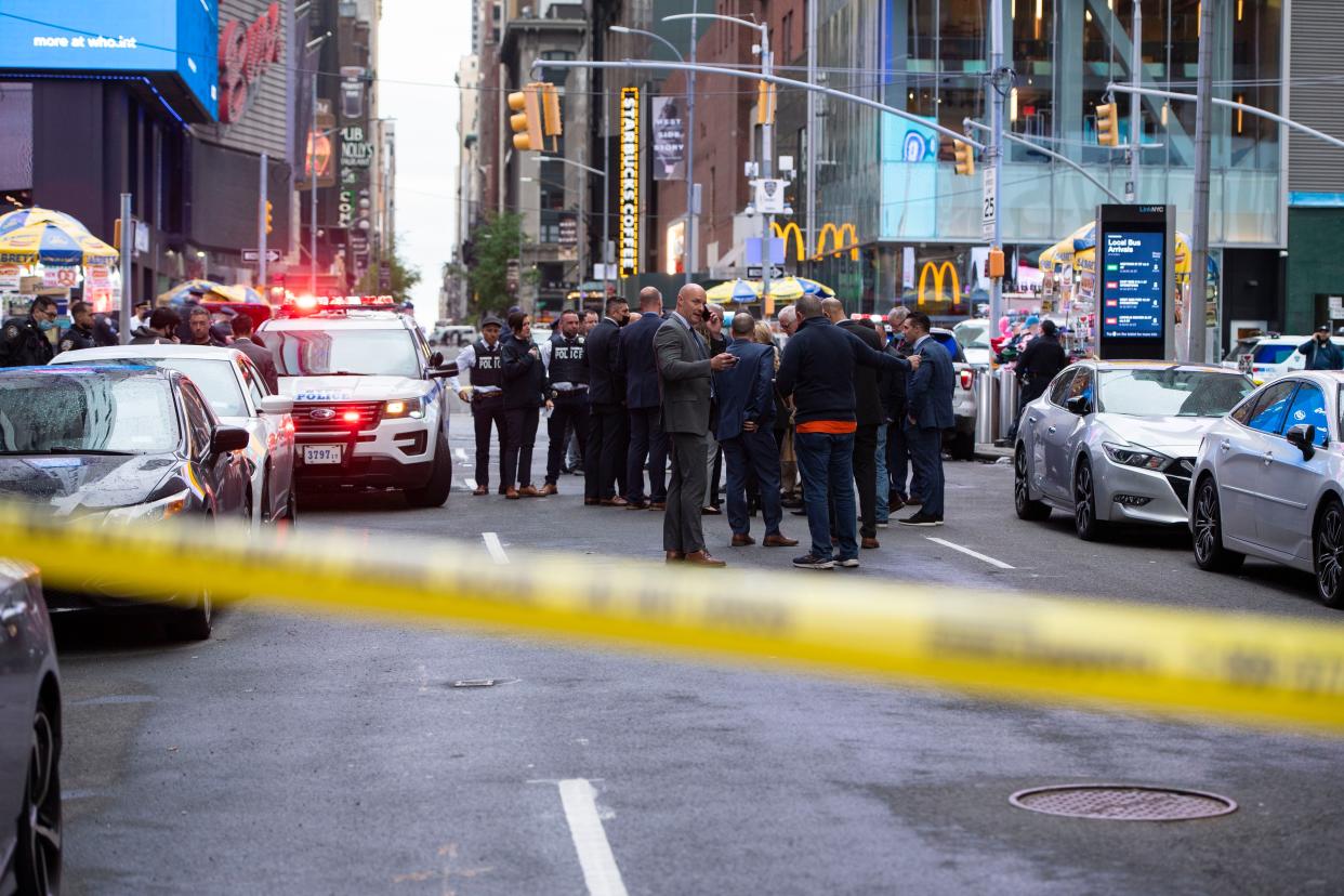 Police on the scene investigating a shooting in Times Square on Saturday, May 8, 2021.  The victims were rushed to a nearby hospital and are expected to survive.