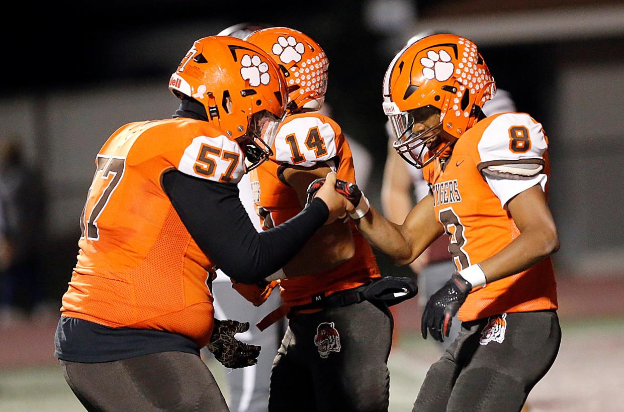 Mansfield Senior High School's Amarr Davis (8) celebrates with Jaden Jones (57) after his second quarter touchdown against Rocky River High School during their OHSAA Division III high Region 10 high school football quarterfinal game action Friday, Nov. 3, 2023 at Rocky River Stadium. TOM E. PUSKAR/MANSFIELD NEWS JOURNAL