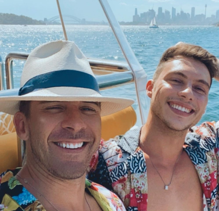 Hugh Sheridan and Kurt Roberts smiling on a boat on Sydney harbour