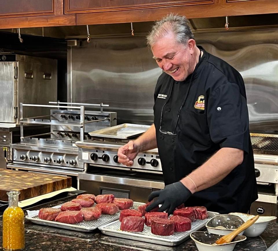 Chef Tony Biggs prepares steaks during a demonstration for caterers at Certified Angus Beef in Wooster. Certified Angus Beef and its chefs created the menu for the Gold Jacket Dinner during the Pro Football Hall of Fame Enshrinement Festival.