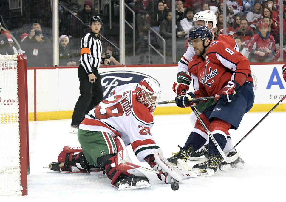 New Jersey Devils goaltender Mackenzie Blackwood (29) deflects a shot as Washington Capitals left wing Alex Ovechkin (8) skates in during the first period of an NHL hockey game Friday, Dec. 20, 2019, in Newark, N.J. (AP Photo/Bill Kostroun)
