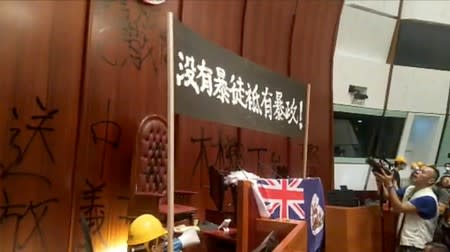 Protesters hold a banner inside the Legislative Council building in Hong Kong