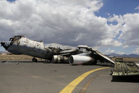 The wreckage of a Yemeni air force military transport aircraft is seen on the tarmac after the aircraft was destroyed by an air strike, at the international airport of Yemen's capital Sanaa May 5, 2015. REUTERS/Khaled Abdullah