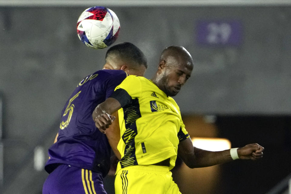 Orlando City's Cesar Araujo, left, goes up against Nashville SC's Fafa Picault, right, for a head ball during the second half of an MLS soccer match, Saturday, April 1, 2023, in Orlando, Fla. (AP Photo/John Raoux)