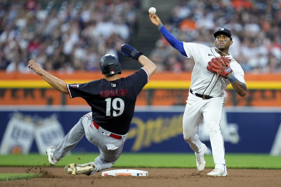 Detroit Tigers second baseman Andy Ibanez, right, throws to first base to complete a double play as Minnesota Twins' Alex Kirilloff (19) slides into second base late in the sixth inning of a baseball game, Saturday, June 24, 2023, in Detroit. (AP Photo/Paul Sancya)