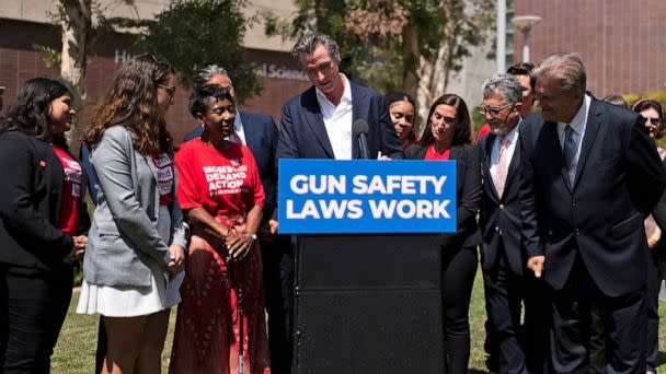 PHOTO: State officials and gun violence survivors watch as California Gov. Gavin Newsom signs a gun control law during a news conference held on the campus of Santa Monica College in Santa Monica, Calif., July 22, 2022. (Jae C. Hong/AP)