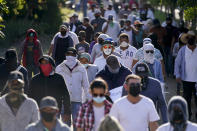 Residents of Aguililla and other nearby communities who are fed up with the army’s strategy of simply separating the Jalisco and the Michoacan-based Viagras gangs, march against roadblocks in Loma Blanca, Mexico, Tuesday, Nov. 16, 2021. Some residents say they are strongly pressured to participate in the protests, fearing their water or electricity might be cut off if they don’t. Others are just tired of paying the Viagras’ war taxes and being cut off from the outside world. (AP Photo/Eduardo Verdugo)