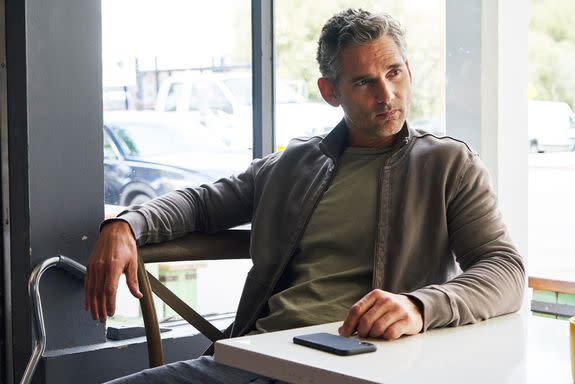 Eric Bana as John Meehan, keeping his phone close.