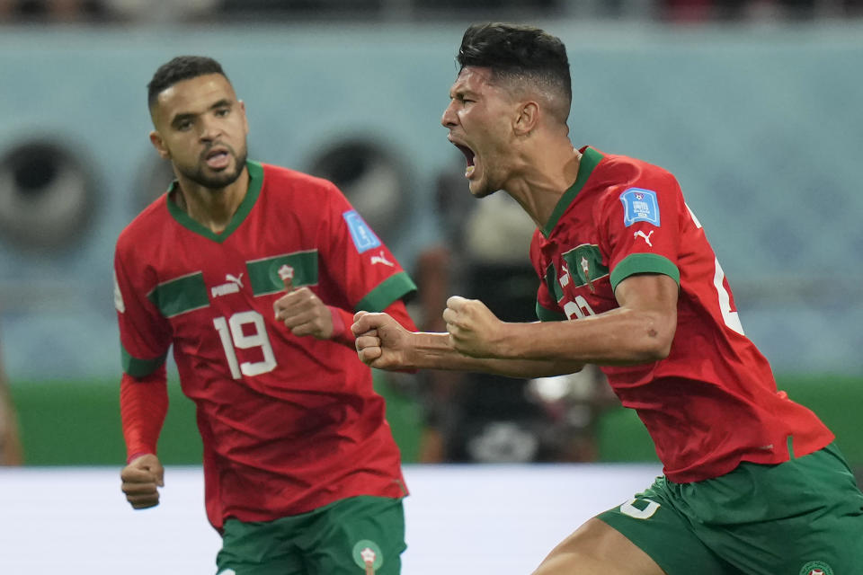 Morocco's Achraf Dari, right, celebrates after scoring his side's first goal during the World Cup third-place playoff soccer match between Croatia and Morocco at Khalifa International Stadium in Doha, Qatar, Saturday, Dec. 17, 2022. (AP Photo/Francisco Seco)