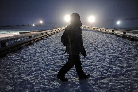 Veterans walk towards the police barricade on Backwater bridge during a protest against plans to pass the Dakota Access pipeline near the Standing Rock Indian Reservation, near Cannon Ball, North Dakota, U.S., December 1, 2016. REUTERS/Stephanie Keith