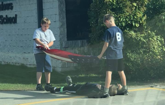 Three fifth-grade boys go viral for properly folding the American flag after school. (Photo: Facebook)