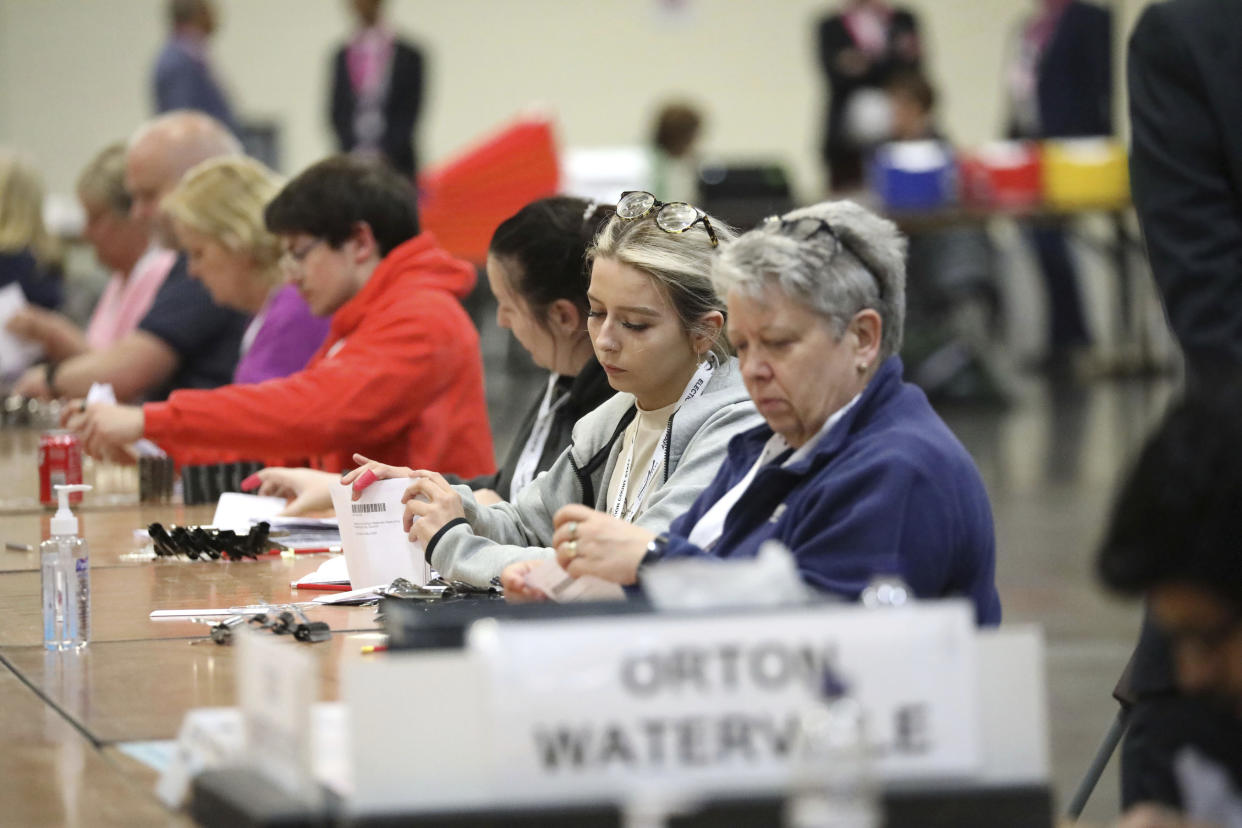 Ballot papers are counted at Peterborough Arena, for the local government elections, in Peterborough, England, Thursday, May 5, 2022. (Paul Marriott/PA via AP)