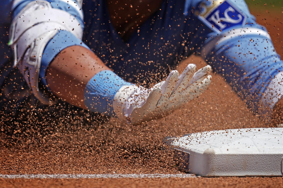 Kansas City Royals' Vinnie Pasquantino slides to third after hitting a triple during the first inning of a baseball game against the Seattle Mariners Sunday, June 9, 2024, in Kansas City, Mo. (AP Photo/Charlie Riedel)