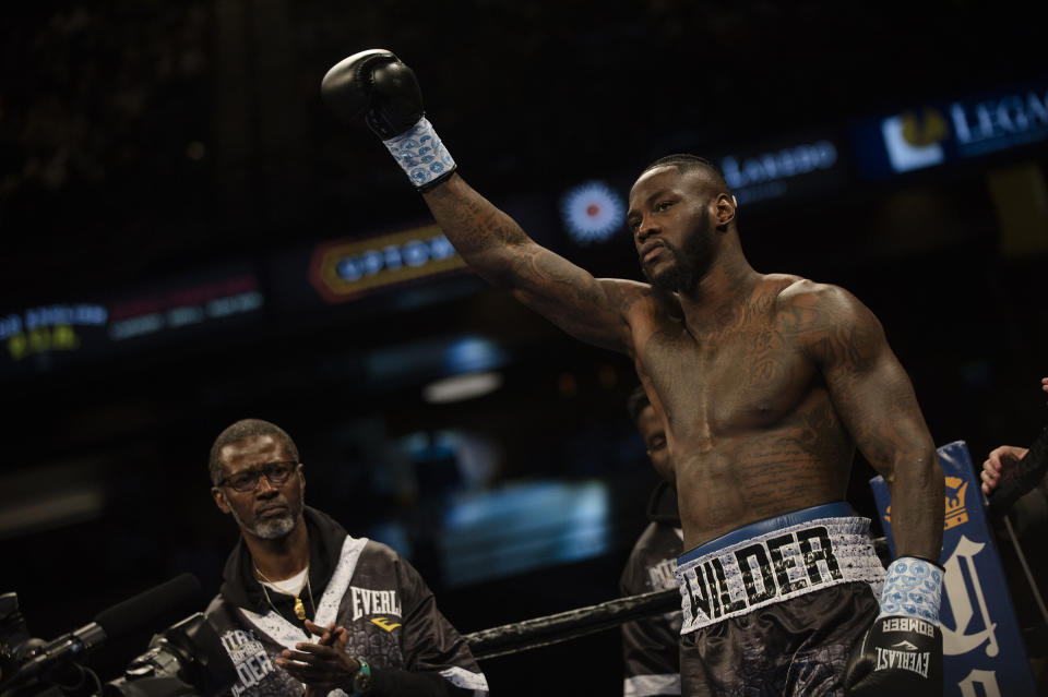 Deontay Wilder raises his glove before his WBC heavyweight title boxing bout against Gerald Washington in February. (AP)