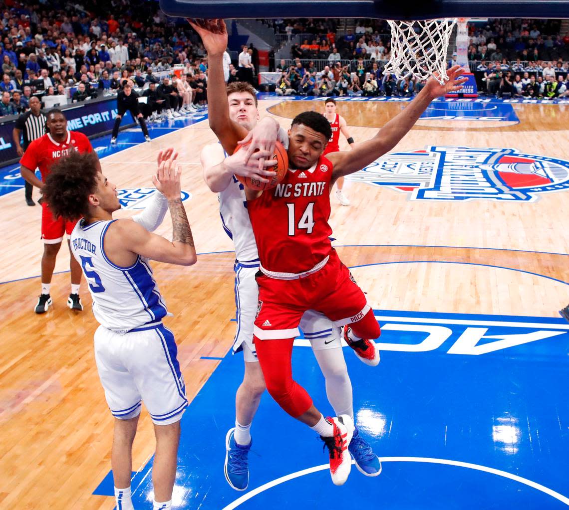 N.C. State’s Casey Morsell (14) pulls a rebound from Duke’s Kyle Filipowski (30) during N.C. State’s 74-69 victory over Duke in the quarterfinal round of the 2024 ACC Men’s Basketball Tournament at Capital One Arena in Washington, D.C., Thursday, March 14, 2024.