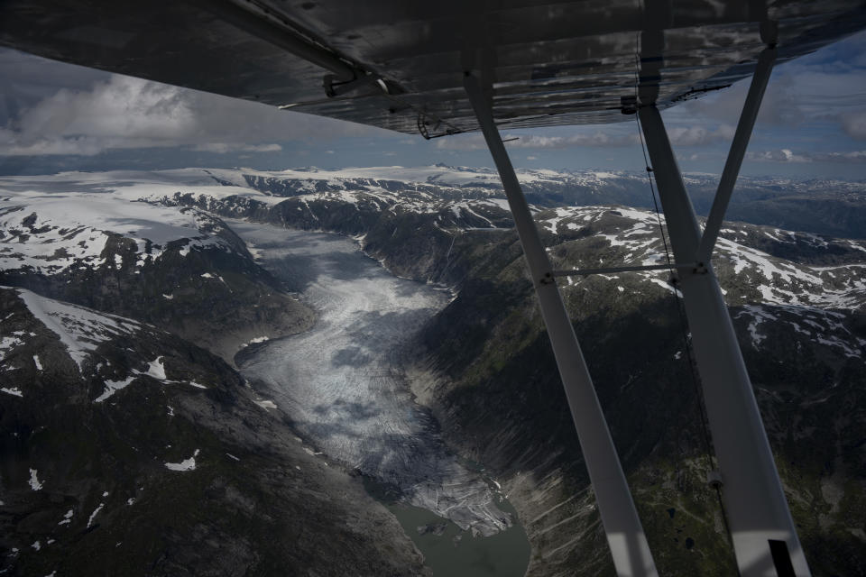 A glacier is seen from Garrett Fisher's plane in Norway, on July 30, 2022. (AP Photo/Bram Janssen)