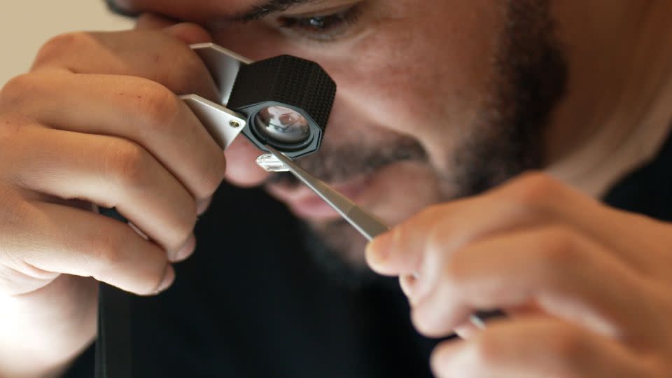 Mohamed Sabeg, co-founder of Dubai-based company 2DOT4, checking a lab-grown diamond. - Paul Devitt / CNN