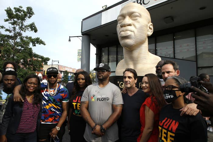 Terrence Floyd (middle in a gray shirt) stands with others during the unveiling of a George Floyd statue in the Flatbush neighborhood of Brooklyn, New York.