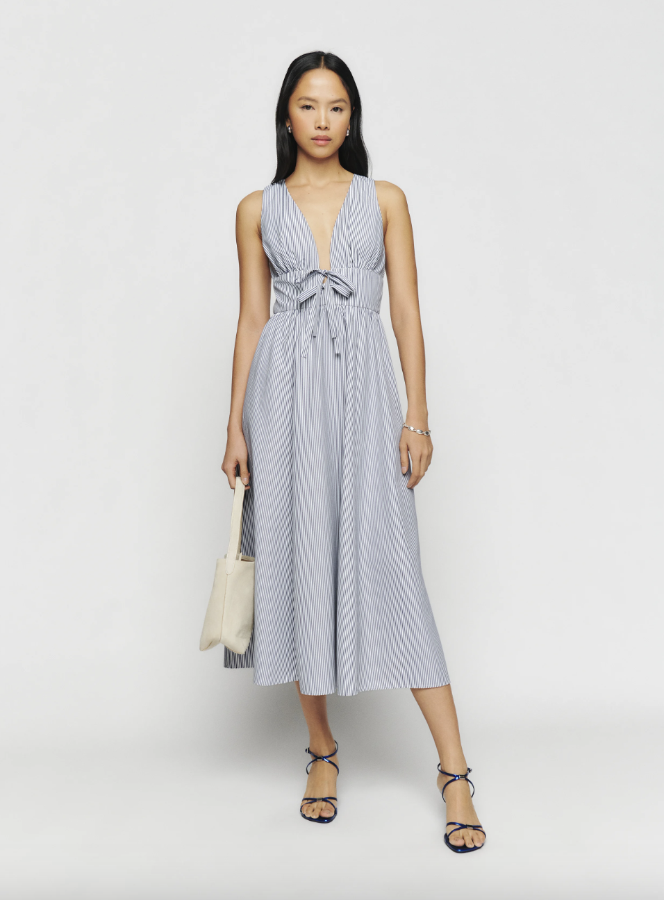 Model in long blue and white Reformation Alvin dress (photo from Reformation)