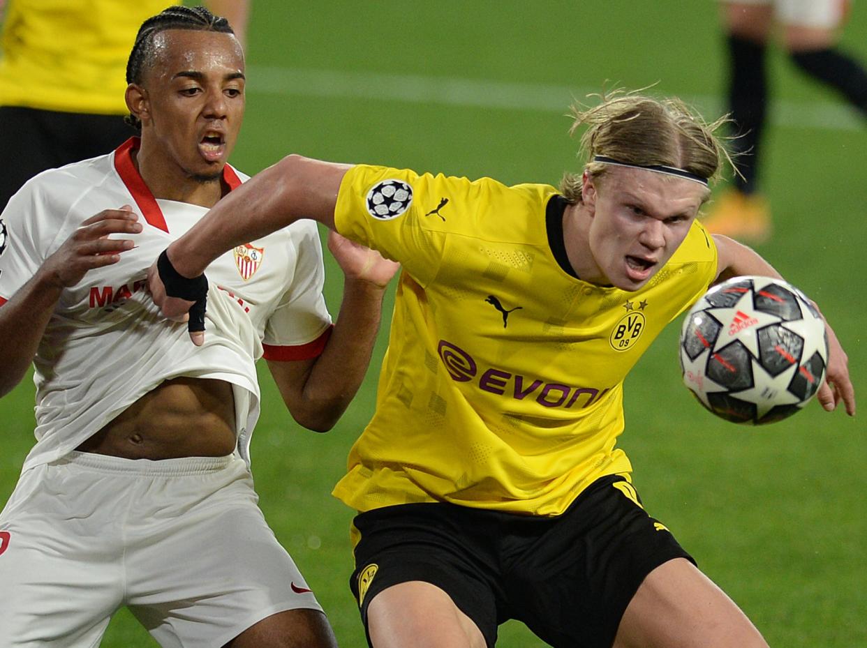 Borussia Dortmund’s Erling Haaland (right) vies with Sevilla’s Jules Kounde (AFP via Getty Images)