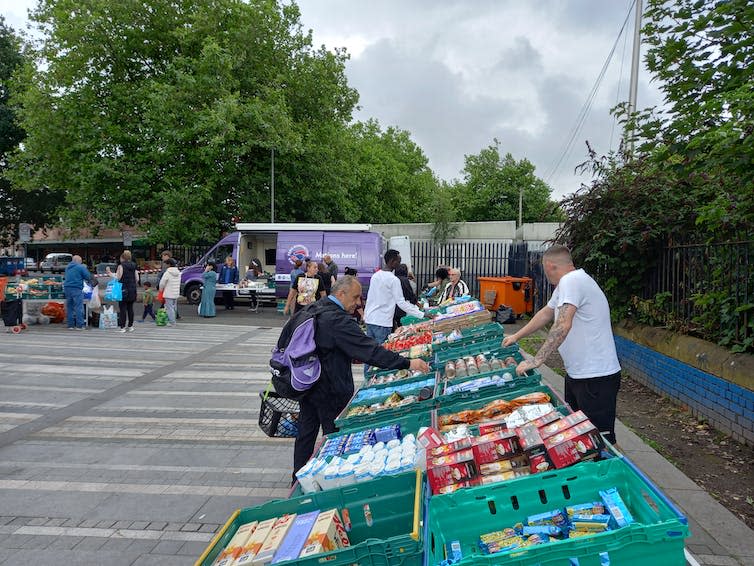 Volunteers hand out food at a mobile pantry for people in need