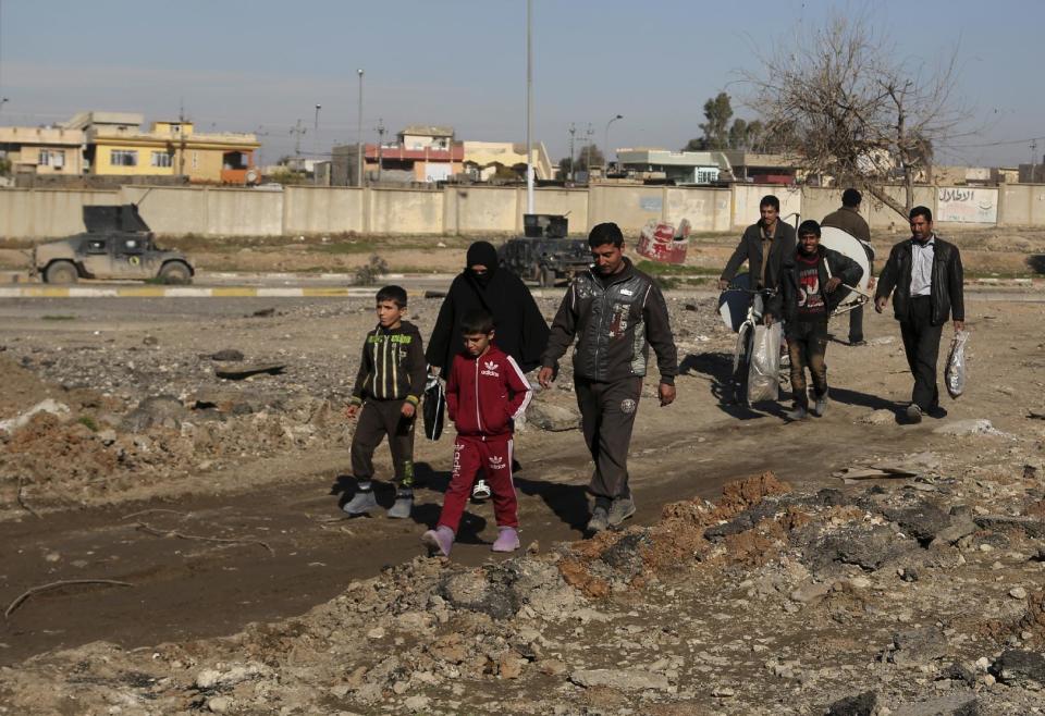 Civilians return to their liberated neighborhoods in the eastern side of Mosul, Iraq, Friday, Jan. 6, 2017. (AP Photo/ Khalid Mohammed)